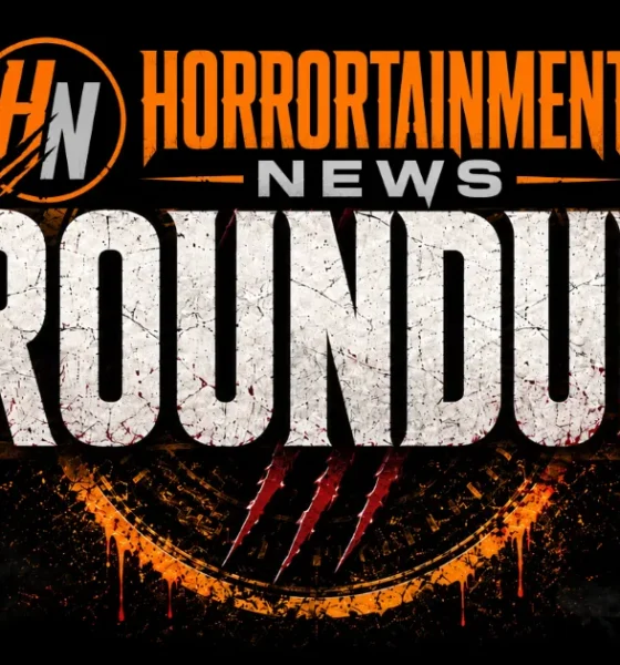 Horrortainment News Roundup logo on a black background. The HN monogram appears in an orange circle at top left, beside the text "Horrortainment News" in orange and silver. Below, "ROUNDUP" is rendered in large distressed white lettering with blood splatter effects, claw marks, and dripping orange and red accents over a smoky, grunge-textured backdrop