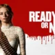 romotional banner for the 2019 horror-comedy film "Ready or Not." A young blonde woman in a torn white lace wedding dress stands against a red background, wearing a bandolier of bullets across her chest. The film's title appears in large white text to her right, with a dripping blood effect along the bottom of the red section.